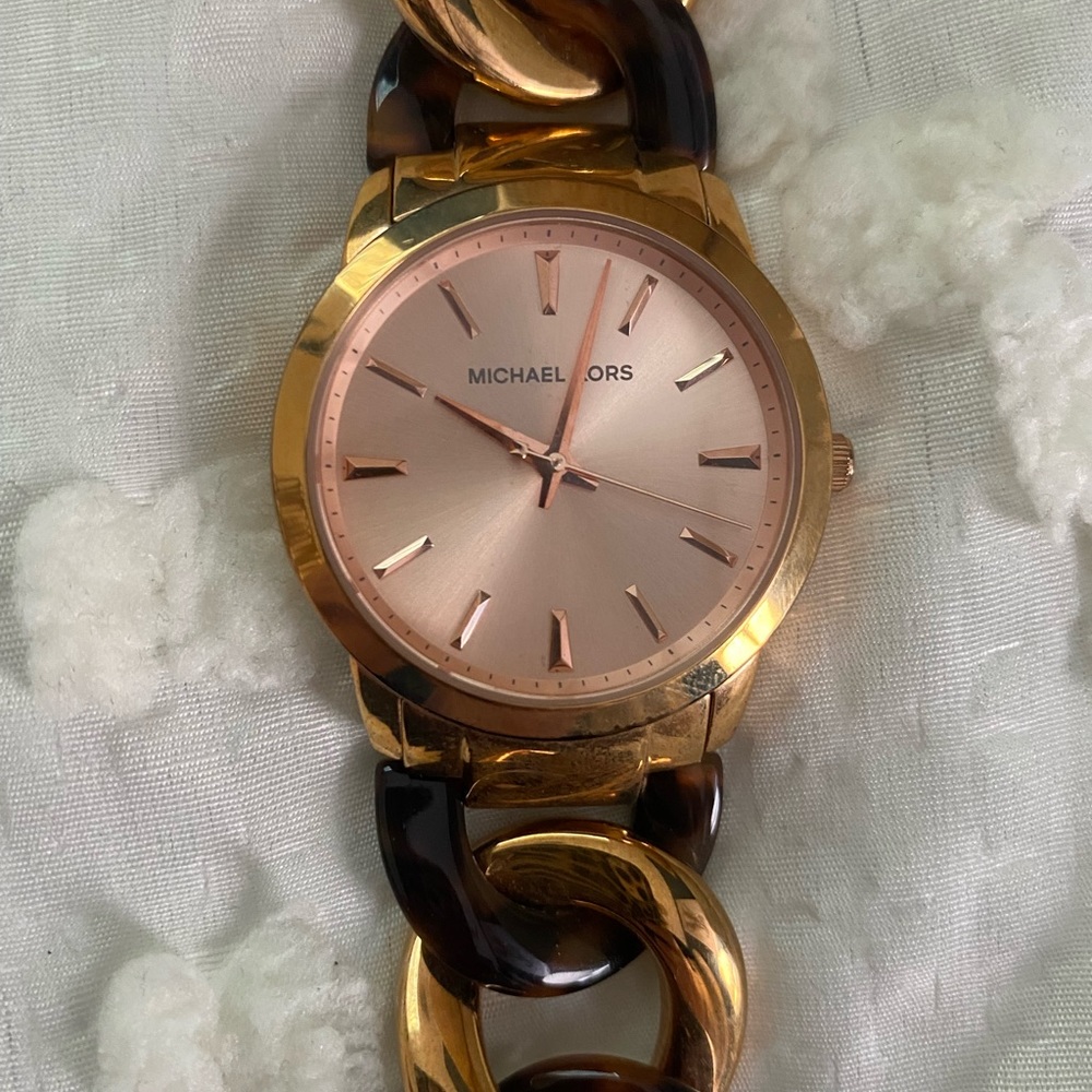 Michael Kors rose gold and tortoise twist watch.